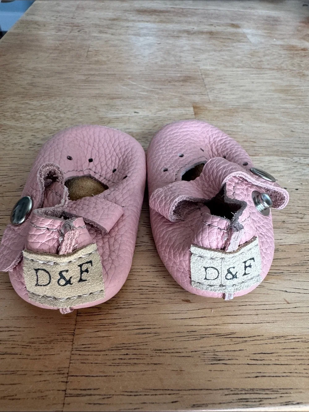 Duchess & Fox soft pink infant shoes.